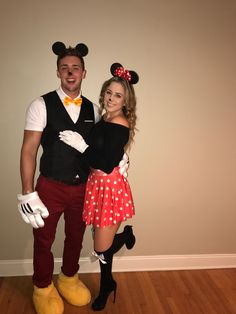 a man and woman dressed up as mickey mouse and minnie mouse from the disney movie