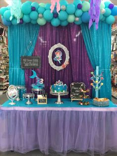 the table is set up for a little mermaid birthday party