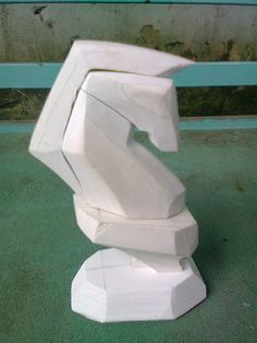 a white sculpture sitting on top of a green floor