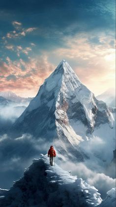 a man walking up the side of a snow covered mountain in front of a cloudy sky