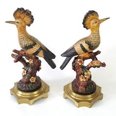 two figurines of birds sitting on top of each other