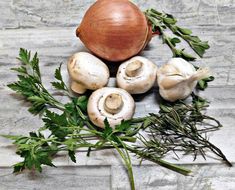 mushrooms and parsley on a stone surface