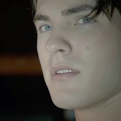 a close up of a person with blue eyes