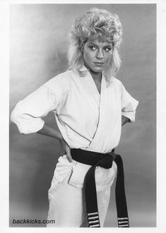 black and white photograph of a woman in karate gear with her hands on her hips