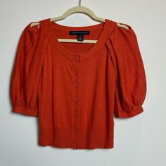 French Connection Orange Cardigan Sweater S Unique Sleeves Style. Excellent Like New Condition, Very Cute Sweater / Cardigan / Top Button Down, Unique Sleeves, Short Sleeves, Hits At Waist, Orange Color, Size Small Aprox Measurements Flat Bust 16” Length 18,5” Waist 13,5” A15 Condition Definitions New With Tags New Without Tags Excellent- No Visible Flaws Or Wear, Almost Like New Very Good - No Significant Flaws Or Wear Fair - (With Explanation) *Measurements Are Approximate *Please See Photos A Short Sleeve Cardigan With Button Closure For Fall, Short Sleeve Sweater With Buttons For Fall, Fall Short Sleeve Button Sweater, Short Sleeve Button Sweater For Fall, Orange Cardigan, Sleeves Style, Cute Sweater, Cardigan Top, Cute Sweaters