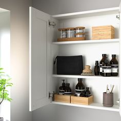 the shelves in the bathroom are filled with personal care products and toiletries, along with plants