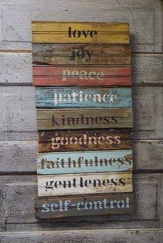 a wooden sign with words on it that say, joy and love in different languages