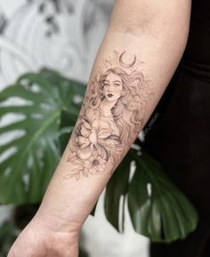 a woman's arm with a flower tattoo on it