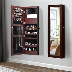 a mirror that is next to a jewelry cabinet