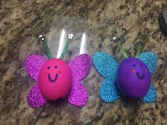 two purple and blue butterflies sitting on top of a counter