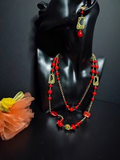 This is a necklace and earring set with bright red Majorca pearls. Beautiful long chain necklace in the style of the 50s composed of aluminum chain, red Mallorcan pearls and golden bronze components. The chain is golden. The pearls are shiny an intense red. The necklace is very elegant, perfect for low-cut evening dresses but also for a single-colored winter sweater to wear every day. The necklace is very long, more than one meter and has no clasp. The earrings include the same golden elements and red pearl drops. This set is perfect for those who love elegant style. All jewels are delivered in a decorated box, ready to be given as a gift to your loved one. How to take care of your jewellery: put on your beauty products (cosmetics, perfumes, ...) before wearing your precious jewel. Clean y Luxury Modern Red Necklace, Luxury Red Necklace With Polished Finish, Luxury Red Necklace With Large Pendant, Long Pearl Necklaces, Red Necklace, Precious Jewels, Long Chain Necklace, Winter Sweater, Majorca