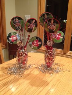 two vases filled with candy canes on top of a wooden table