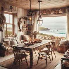 a dining room with a table and chairs next to a window looking out onto the ocean