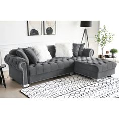 a living room with grey couches and white rugs