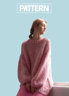 a woman wearing a pink sweater and pleated skirt sitting on a window sill