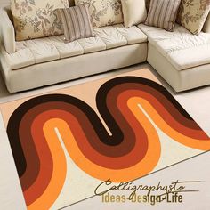 a living room area rug with an orange and brown swirl design on the floor next to a white couch