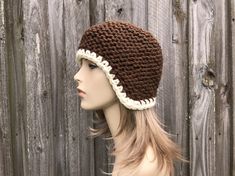 "Knit Hat Style: Garter Helmet - a chunky ear flap hat for women, men and teens. Color: This sample hat is shown in Chocolate Brown with Cream trim. Sizes: One size fits average teen or adult head size of 20\" to 23\" (50.5 cm to 58 cm). Fiber Content: 100% acrylic Characteristics: Whimsical, chunky, very soft, warm and cozy. Care Instructions: Hand wash, dry flat. Every item from Pixiebell is handmade and knit or crocheted to order, unless otherwise stated in title of the item as \"ready to shi Warm Yarn Crochet Hat With Ear Flaps, Brown Outdoor Crochet Hat, Brown Crochet Hat For Cold Weather, Crochet Brown Beanie For Winter, Brown Hand Knitted Hat In Acrylic Yarn, Hand-knitted Brown Hat In Acrylic Yarn, Cozy Brown Crochet Hat In Acrylic Yarn, Brown Handmade Crochet Hat For Outdoor, Knitted Brown Acrylic Yarn Hats