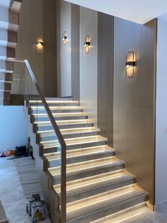 there is a set of stairs with lights on the wall and below it are two lamps