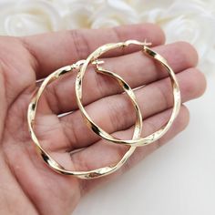 Stunning real 14k yellow gold polished 3mm thick twisted hoop earrings. Perfect for everyday and special occasions. Shiny, elegant and versatile. Perfect gift for her. A must have in your earrings collection. Materials: 14k Yellow Gold Diameter: 46mm Thickness: 3mm Weight: approximately  3.9 grams 14k stamped Brand new  Fast shipping  Check out or 42mm 14k Gold 3mm Twisted Hoop Earrings: https://www.etsy.com/BrizaCollections/listing/1440449027/real-14k-gold-3mm-twisted-hoop-earrings?utm_source=C Cheap Gold Alloy Earrings, Cheap Modern Gold Plated Hoop Earrings, Cheap Gold Hoop Earrings For Party, Cheap Gold Alloy Hoop Earrings, Cheap Elegant Polished Hoop Earrings, Cheap Elegant Hoop Earrings, Elegant Cheap Gold Plated Hoop Earrings, Cheap Cadmium-free Gold Earrings, Cheap Gold Hoop Jewelry