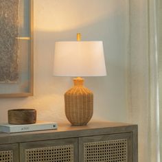 Light and breezy. Our table lamp's woven rattan base offers a casually refined look, perfect for boho chic or coastal-inspired spaces. The voluminous silhouette showcases natural textures and a warm artisanal appeal. A white linen shade softly diffuses light, brightening up your side table, console, or nightstand. Plus, the rotary socket switch makes it easy to set the mood just right. Something to keep in mind: a bulb is sold separately. Joss & Main | Joss & Main Kelta Table Lamp in Brown | Siz Rattan Table, Fixture Table, Table Console, Entryway Console, Minimal Space, Buffet Lamps, Woven Rattan, Metal Lamp, Curtain Accessories