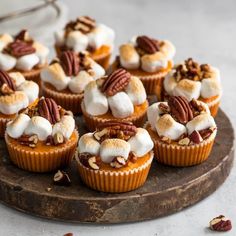 there are many cupcakes with nuts and cream toppings on the top one