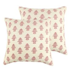 two red and white pillows sitting next to each other