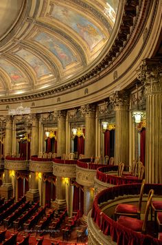 an ornately decorated auditorium with red velvet seats