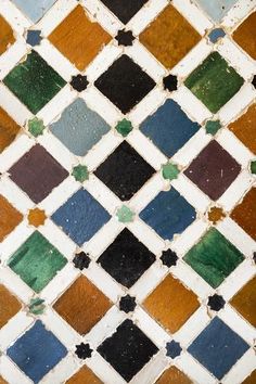 an old tile with different colors and shapes