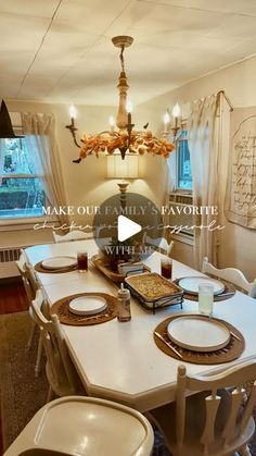 the dining room table is set with place settings