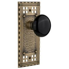 an antique style door handle with a black knob