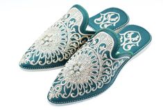 We made our Moroccan Babouche from high-quality leather and features a pointed toe and a flat heel. The leather upper is adorned with intricate embroidery and beadwork, adding a bohemian flair to these slippers. The rubber outsole provides traction and stability, making these slippers suitable for indoor and outdoor wear. Not only are these embroidered shoes Babouche stylish, they are also comfortable and practical. The pointed toe and flat heel provide a comfortable fit, and the leather upper is soft and supple, making these slippers a joy to wear. Whether you're running errands or lounging at home, our Babouche will keep your feet comfortable and stylish. Enhance your bridal attire with our luxurious Moroccan Bridal Slippers in Blue. Handcrafted by skilled artisans in Morocco, these slip Traditional Closed Toe Mules For Festive Occasions, Traditional Formal Slip-on Slippers, Traditional Embroidered Mules, Traditional Pointed Toe Mules, Traditional Embroidered Slip-on Slippers, Traditional Embroidered Closed Toe Mules, Slippers Embroidered, Moroccan Shoes, Moroccan Slippers