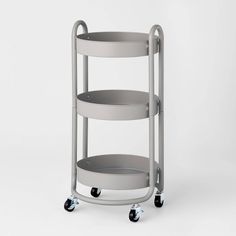 a three tiered serving cart with wheels on the front and bottom, in grey