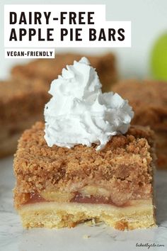 a piece of pie with whipped cream on top and the words dairy - free apple pie bars above it