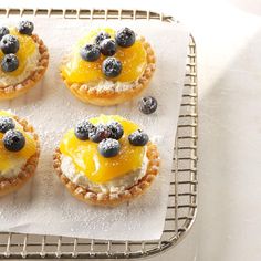 small pastries with blueberries and lemon on a cooling rack