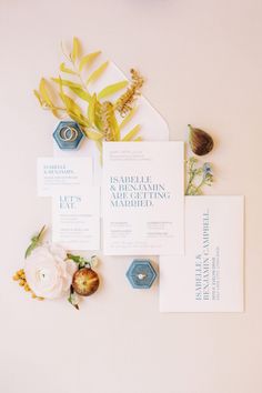 the wedding stationery is laid out on top of each other