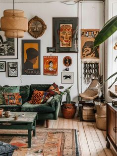 a living room filled with furniture and lots of pictures on the wall next to a window