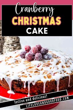 a cake with white icing and cranberries on top is sitting on a red plate