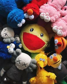 many different colored stuffed animals are arranged together