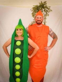 two people dressed up as peas and carrots, one in an orange dress with green hair