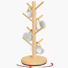 a wooden rack with cups and spoons hanging from it's sides on a white background