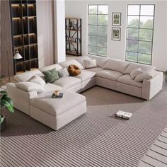 a living room with a large sectional couch and pillows on the bottom half of it