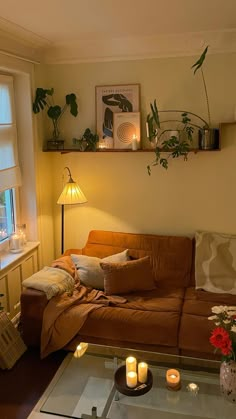 a living room filled with furniture and lots of candles on top of the coffee table