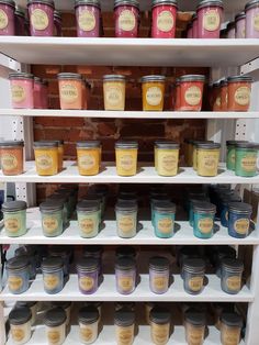 the shelves are filled with different types of jams