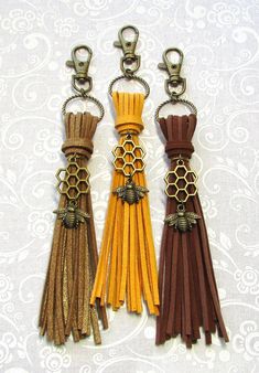 three key chains with different colored tassels hanging from them