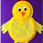 a paper plate with a yellow chicken on it's head and legs, sitting in front of a purple background