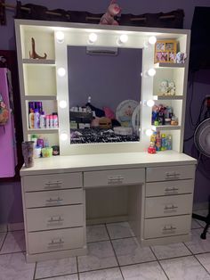 a vanity with lights and drawers in a room