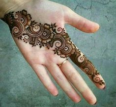 the hand is decorated with henna designs