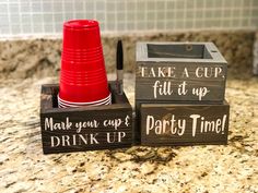 two wooden signs that say take a cup, fill it up, and drink up