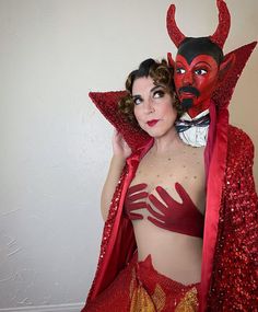 a woman dressed in red and wearing a devil costume