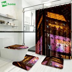 a bathroom with a toilet, shower curtain and rugs in the shape of louis vuitties